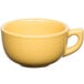 A close-up of a yellow Tuxton China cappuccino cup with a handle.