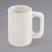 A Tuxton Texan eggshell white china mug with a handle.