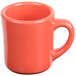 An orange Tuxton china mug with a white interior and handle.