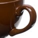 A close-up of a Tuxton mahogany cappuccino cup with a handle.