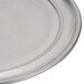 An American Metalcraft aluminum pizza pan with a wide rim on a counter.