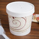 A white Solo paper soup cup with a white vented lid.