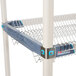 A MetroMax iQ stainless steel drop-in rack with metal hooks on the sides.