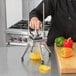 A person using a Nemco Easy Chopper to dice yellow bell peppers.