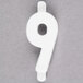 A white molded plastic number 9 deli tag insert.