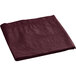 A folded burgundy Hoffmaster tissue/poly table cover on a white background.