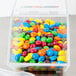 A Cal-Mil stackable plastic container filled with colorful candies.