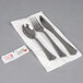 A WNA Comet Reflections plastic silverware set with a spoon and fork on a napkin.
