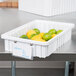 A white Metro Divider Tote Box with limes and lemons in it.