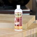 A 16 oz. squeeze bottle of Emmet's Elixir Wood Conditioner on a wooden surface.