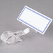 A clear plastic clip with a blue and white checkered border.