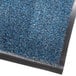 A blue carpet entrance mat with a black border.