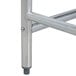 A metal table leg on an Advance Tabco stainless steel work table.