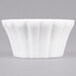 A white CAC China ramekin with a wavy floral design.