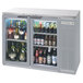 A Beverage-Air stainless steel back bar refrigerator filled with bottles of beer.