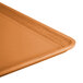 An orange rectangular Cambro dietary tray on a counter.