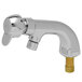 A silver T&S deck mounted metering faucet with a gold nut.