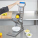 A person using an Edlund ARC! fruit and vegetable slicer to cut lemons.