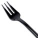 A WNA Comet black plastic tasting fork.