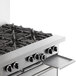 A stainless steel Garland commercial gas range with eight burners, a standard oven, and a storage base.