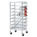 A white metal Advance Tabco aluminum can rack filled with cans.