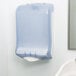 A San Jamar Ultrafold large capacity plastic towel dispenser in arctic blue on a wall.