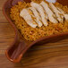 A CAC brown Fry Pan Plate with chicken and rice on top.