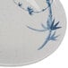 A close-up of a Thunder Group Blue Bamboo melamine plate with a white and blue bamboo design.