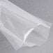 An ARY VacMaster clear plastic vacuum packaging bag on a gray surface.