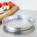 An American Metalcraft heavy weight silver aluminum pizza pan with holes.