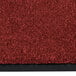 A crimson carpet with a black border.