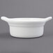 A white Tuxton eggshell china bowl with two handles.