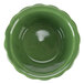 A close-up of a green CAC china ramekin with a scalloped edge.