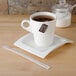A cup of tea with a Royal Paper wood coffee stirrer on a plate.