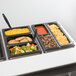 A Cambro black plastic 1/4 size food pan with different types of food in it.