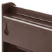 A brown plastic shelf with clips for Vollrath condiment holder.