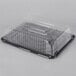 A D&W Fine Pack 1/4 Size Sheet Cake Display Container with a clear plastic lid.