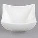An Arcoroc white square porcelain bowl with a curved edge.