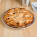 An American Metalcraft aluminum pie pan with a pie and lattice top on a table.