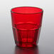 A red GET Bahama plastic tumbler filled with a clear liquid on a table.