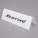 An American Metalcraft white plastic table tent with black text that says "Reserved" on both sides.