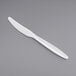 A Visions white plastic knife on a gray background.