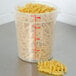 A Cambro translucent round polypropylene food storage container filled with pasta.