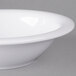 A close-up of a white Carlisle rimmed melamine bowl.