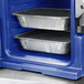 A blue Cambro front loading insulated food pan carrier with two trays of food inside.
