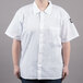 A woman wearing a white Chef Revival short sleeve cook shirt.
