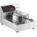 A Nemco 7030A Waffle Cone Maker on a counter with a button on the top.