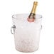 A Cambro clear polycarbonate wine bucket filled with ice and a champagne bottle.