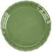 A close-up of a green fluted CAC China quiche dish with a scalloped edge.
