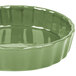 A green fluted quiche dish with a rim.